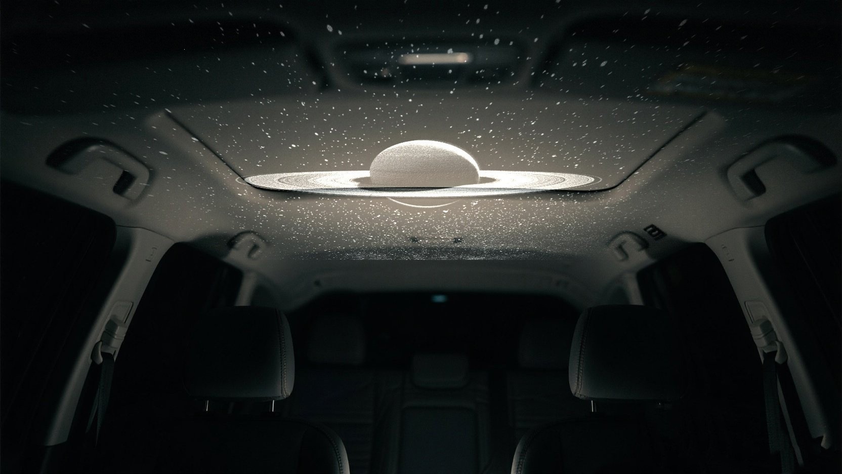 Saturn and star projection across a parked car ceiling